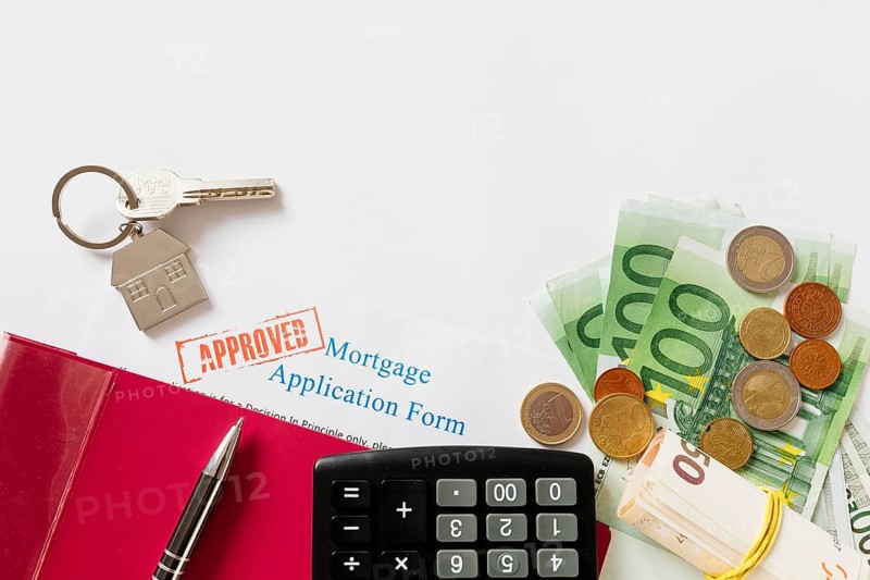 Approved mortgage contract key with money