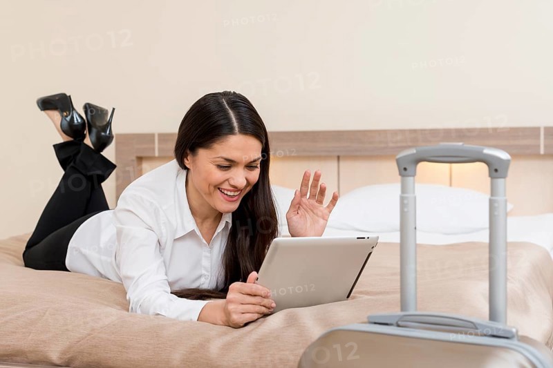 Woman using tablet hotel room