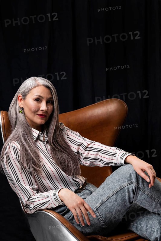 Side view beautiful senior woman portrait posing chair