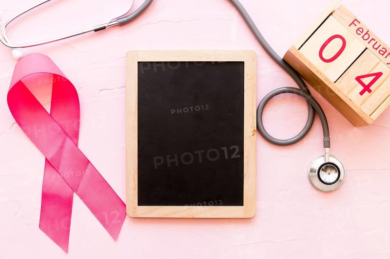 World cancer day awareness ribbon with stethoscope wooden slate 4th february wooden box