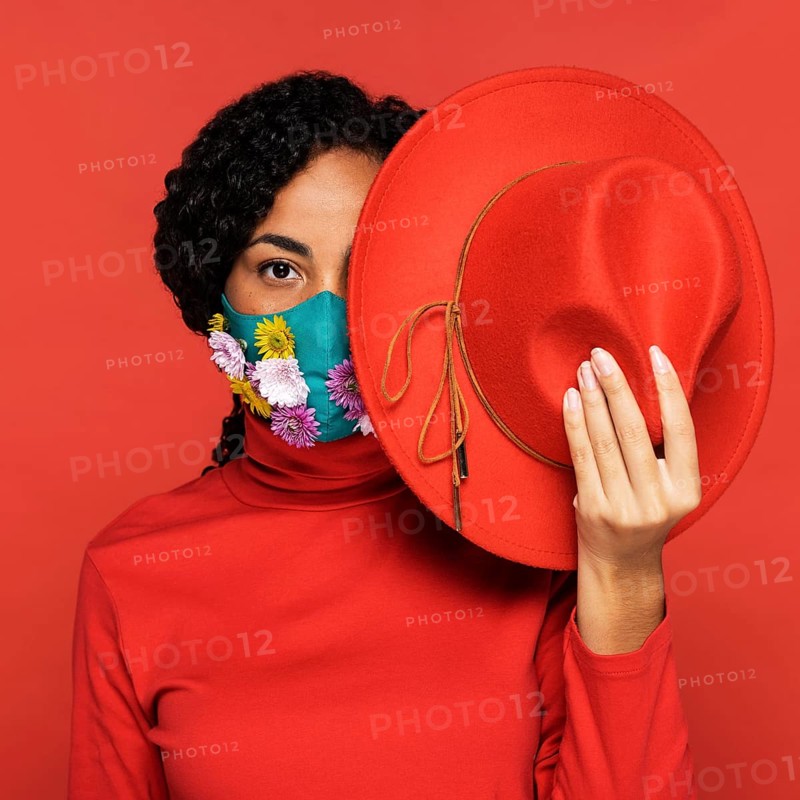 Front view woman with flowers her mask posing with hat