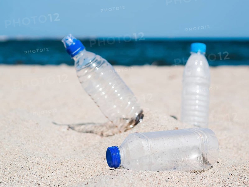 Plastic waste empty bottle sand beach