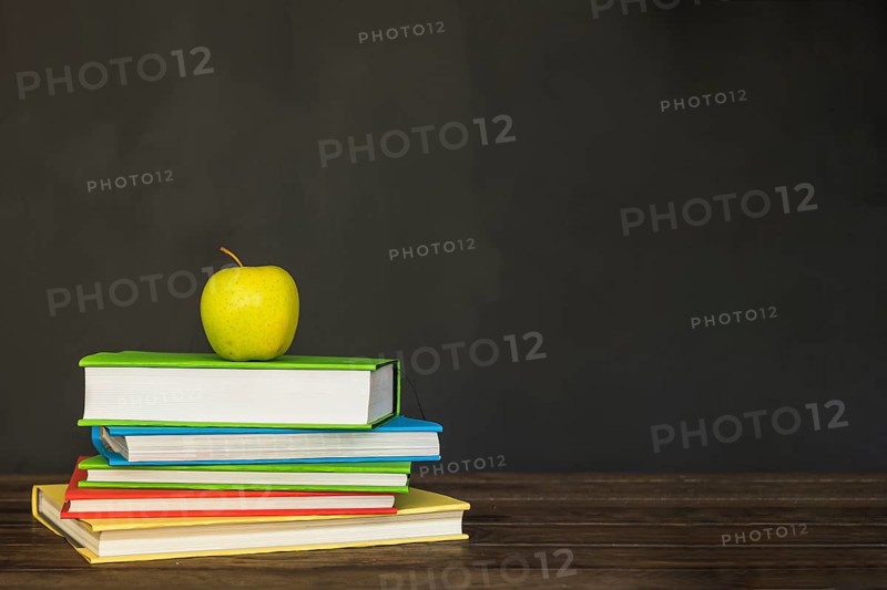 Wooden desk with books apple