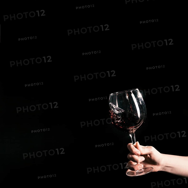 Crop hand holding glass wine