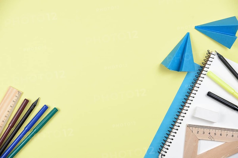 Office stationaries folded paper yellow background
