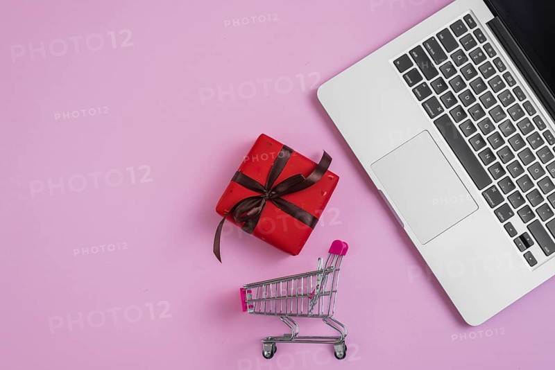 Toy shopping trolley present near laptop keyboard