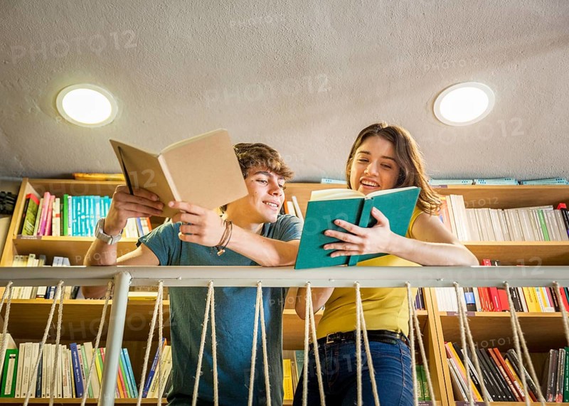 Teen girl showing book boyfriend