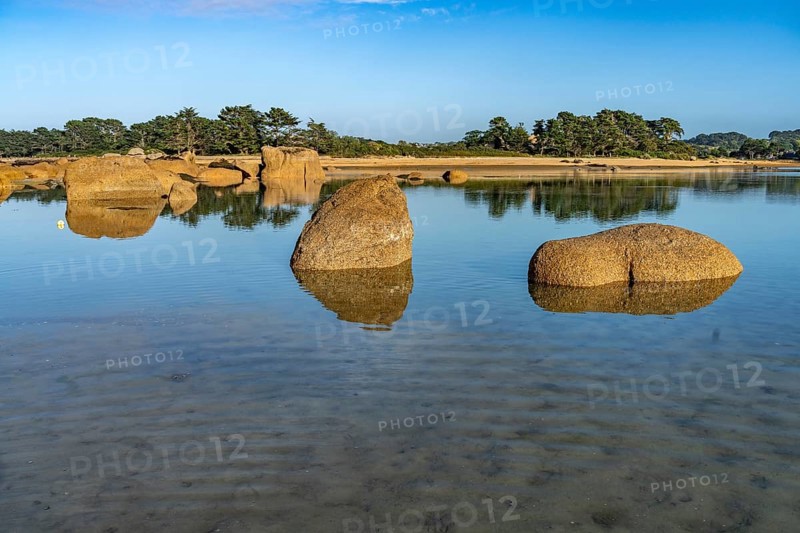The rocks of the pink granite coast Cote de Granit Rose at the Baie de Sainte Anne near Tregastel