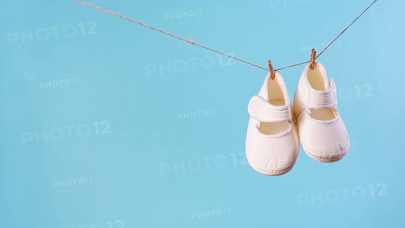 Front view cute little baby shoes with copy space