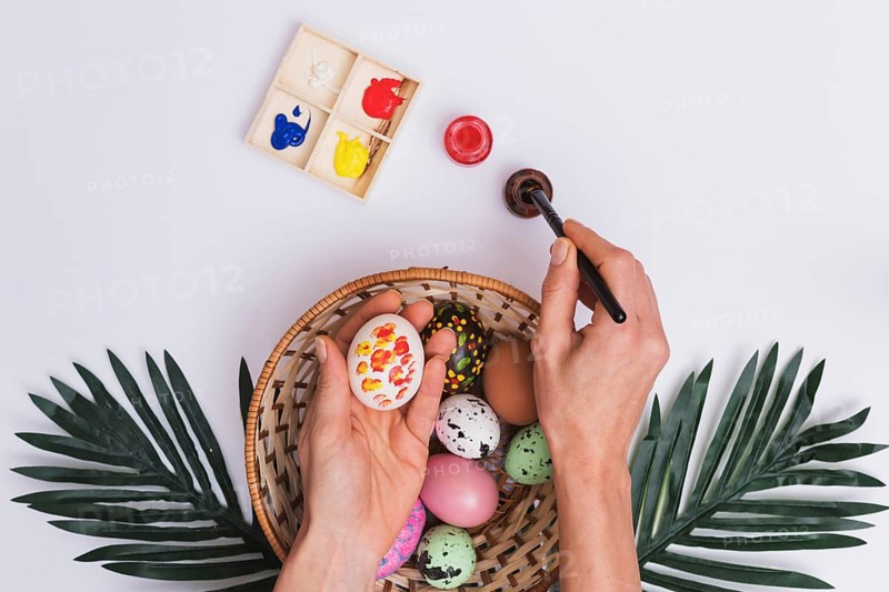 Crop hand painting eggs bowl