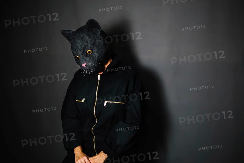Person cat mask dark room