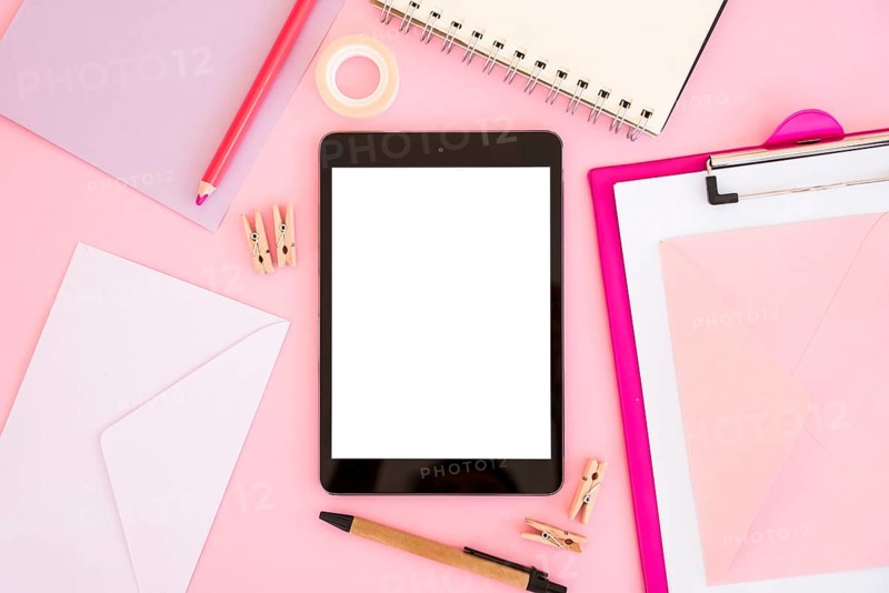 Top view tablet with pink stationery
