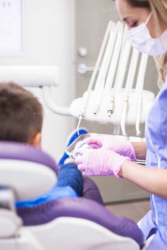 Female dentist looking teeth plaster mold clinic