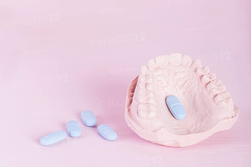 Dental model plaster cast pills pink background