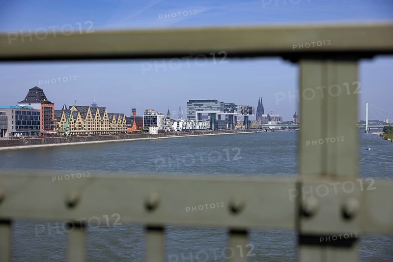 View of the city of Cologne and the Rhine through the railing of the South Bridge with Rheinauhafen