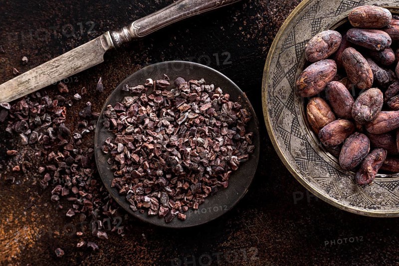 Top view grounded cocoa beans plate with knife cocoa beans