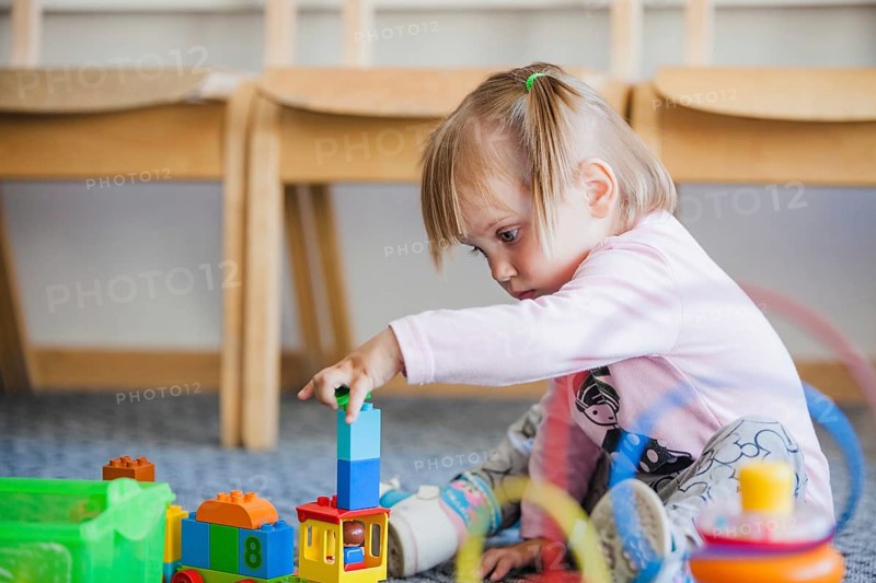 Girl stacking toys playroom