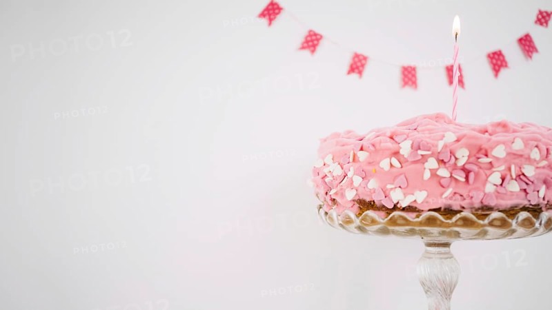 Pink cake decorated with candle