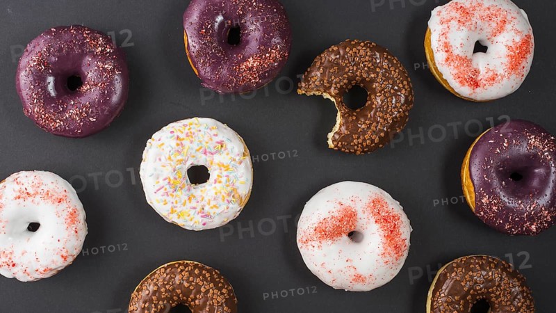 Set delicious sweet bitten donuts with colorful coating