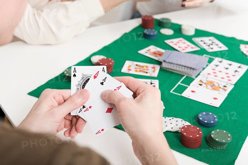 Close up person playing poker