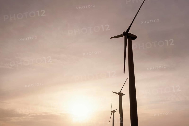 Low angle wind turbines sunset generating energy