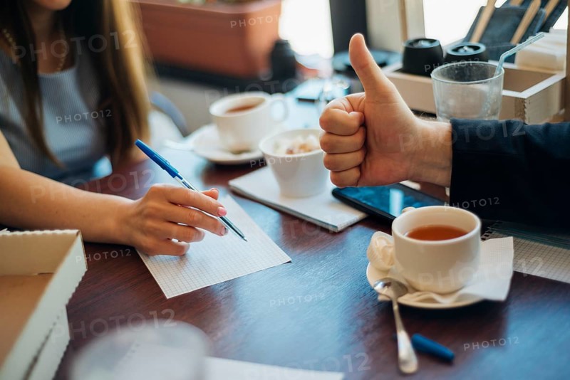 People brainstorming drinking tea cafe