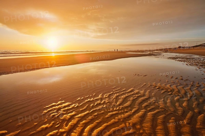 Atlantic ocean sunset with surging waves at Fonte da Telha beach
