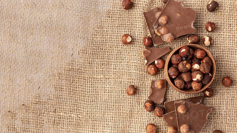 Top view chocolate with hazelnuts burlap copy space