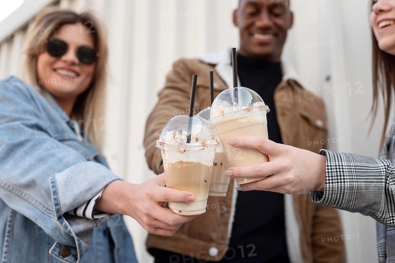 Friends hanging out while enjoying cup coffee