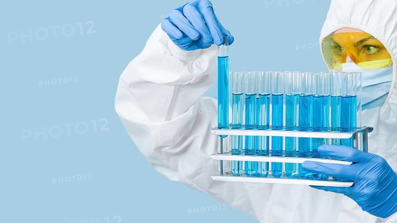 Scientist looking blue chemicals