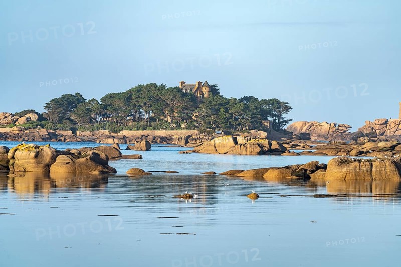 The rocks of the pink granite coast Cote de Granit Rose at the Baie de Sainte Anne near Tregastel and Costaeres Castle