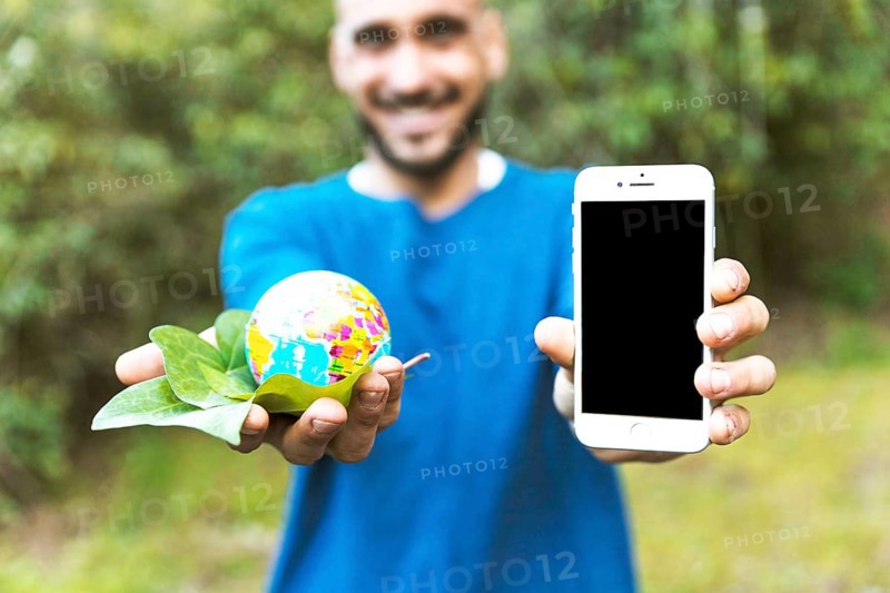 Man holding globe with leaf smartphone