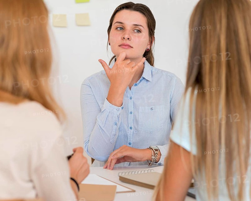 Woman teaching sign language other people