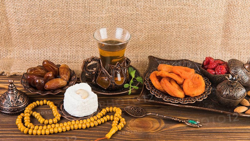 Tea glass with dried fruits beads wooden table