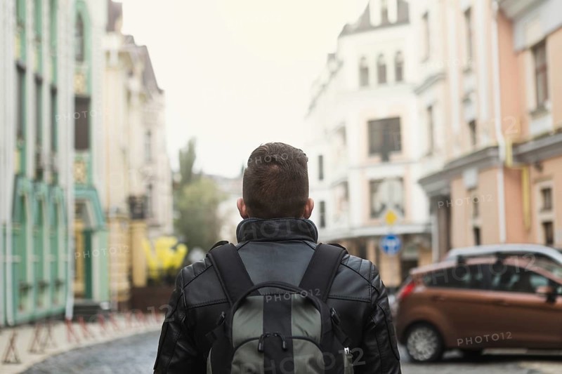 Man with backpack old street