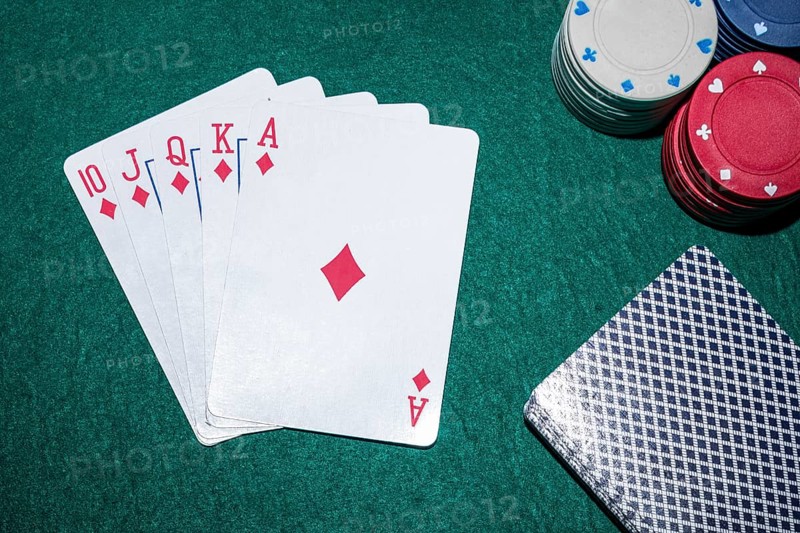 Royal flush playing cards with casino chips poker table