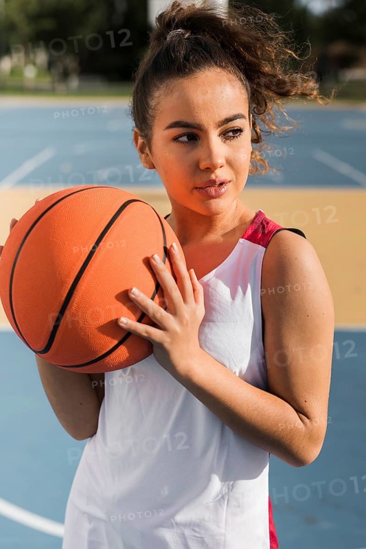 Front view girl holding basketball ball