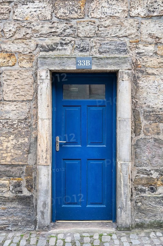 Blue front door on an old stone house