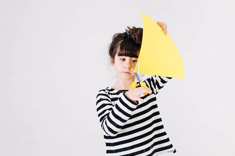Sweet girl cutting paper