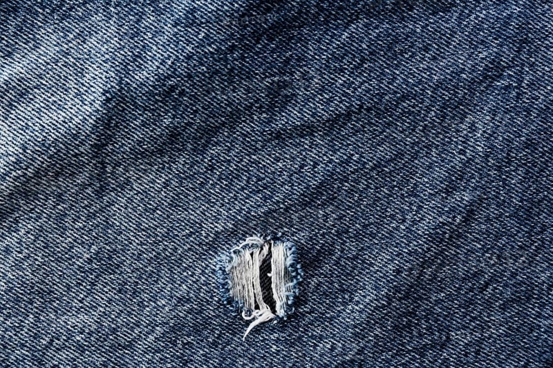 Coarse denim surface with tear