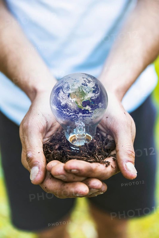 Concept hands holding earth bulb
