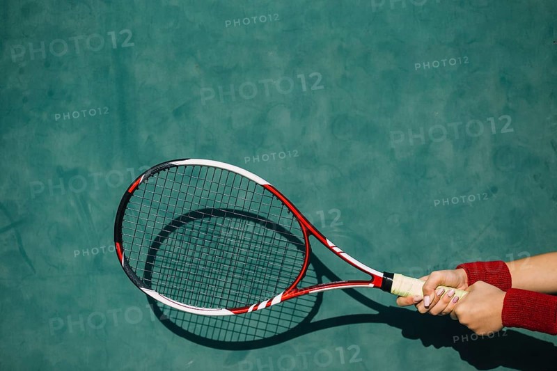 Woman holding tennis racket both hands