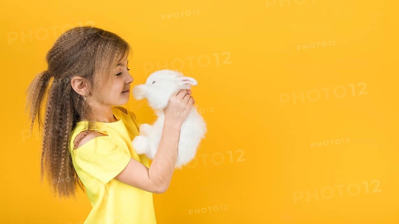 Cute girl looking white rabbit