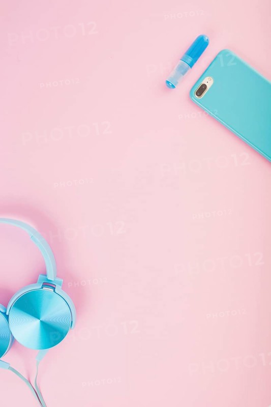 Elevated view headphone smartphone pink background