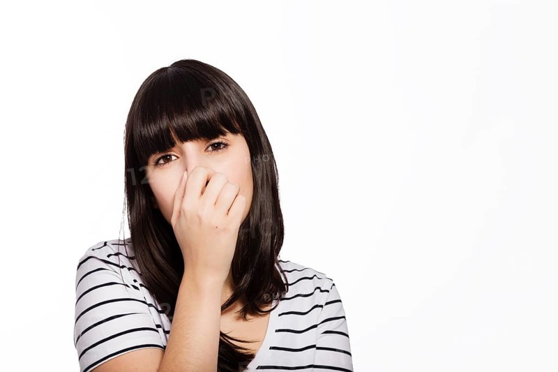 Woman covering nose