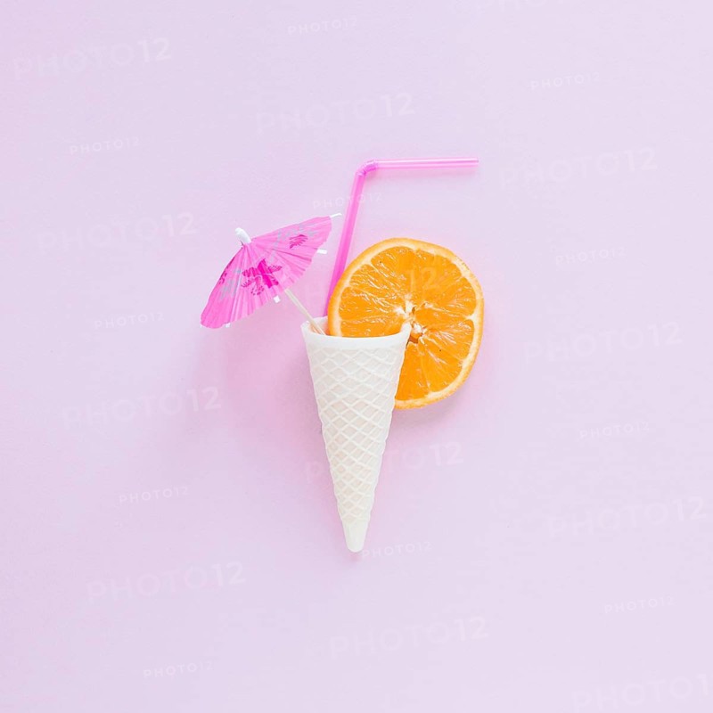 Waffle cone with orange straw umbrella table