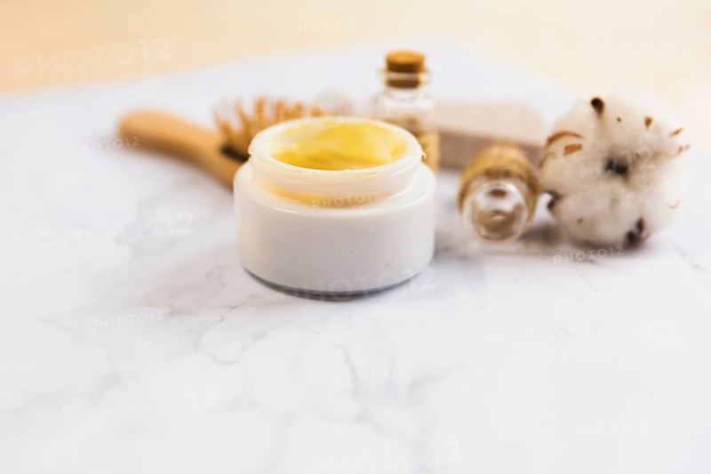 Close up beauty cream bottle cotton flower plant