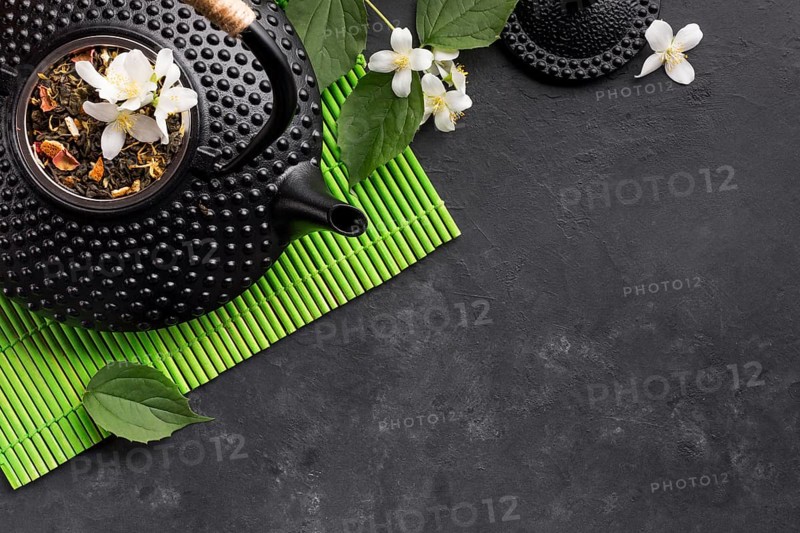 Dried tea herb white jasmine flower black background