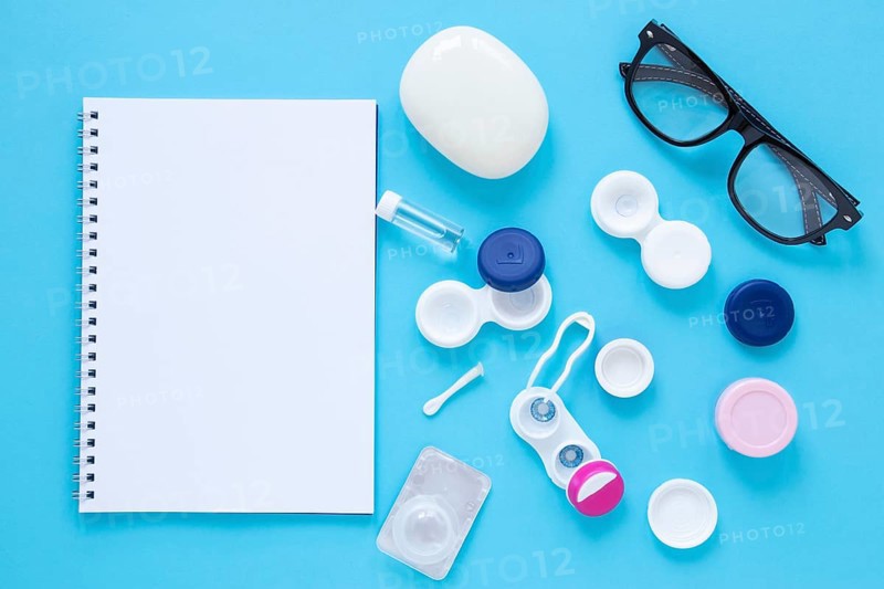 Eye care products blue background with notebook mock up