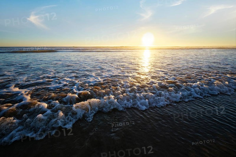 Atlantic ocean sunset with surging waves at Fonte da Telha beach